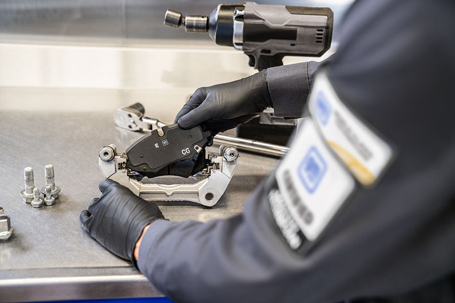 Mechanic working on car brakes